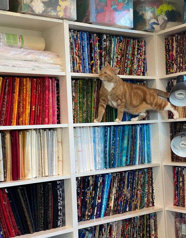 Picture of shelves full of fabrics