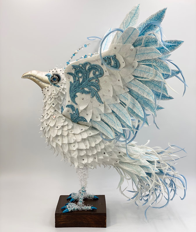 Side view of Hope, a white phoenix textile sculpture by Linda Blust