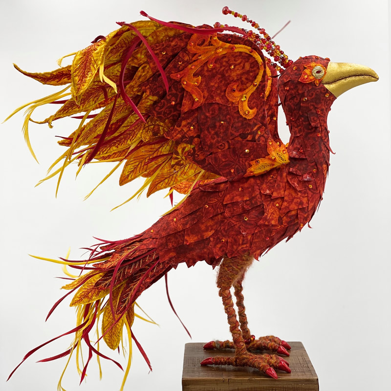 Reemergence, a textile art phoenix sculpture side view with pedestal